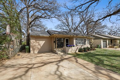 View of front of property featuring fence, concret