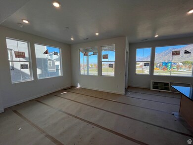 Unfurnished living room with healthy amount of natural light, recessed lighting, and a mountain view