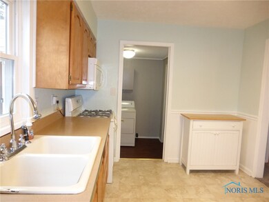 KITCHEN LOOKING INTO 1ST FLOOR LAUNDRY