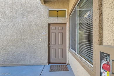 Doorway to property featuring stucco siding