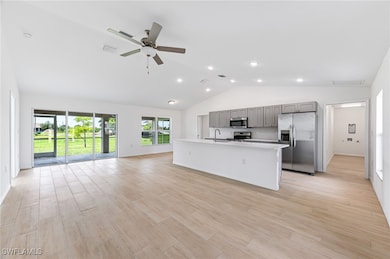 Kitchen with light countertops, gray cabinetry, ap