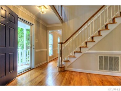 The two story foyer is welcoming with beautiful ha