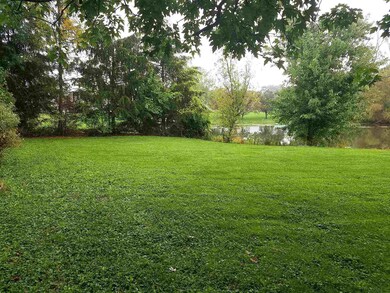 Private yard by pond.