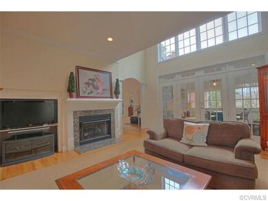 Living room with recessed lights, doors to screene