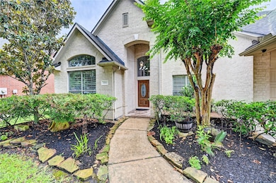 Two story front entryway features a grand staircas