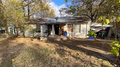 Rear view of property with a metal roof