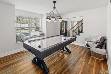 Rec room featuring baseboards and dark wood-type flooring