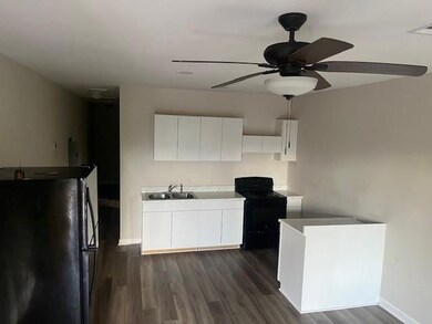 Kitchen with black appliances, a sink, a ceiling f