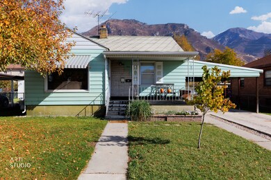 Bungalow-style home featuring a porch, a mountain view, a front yard, and a chimney