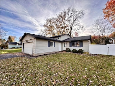View of front facade featuring an attached garage and driveway