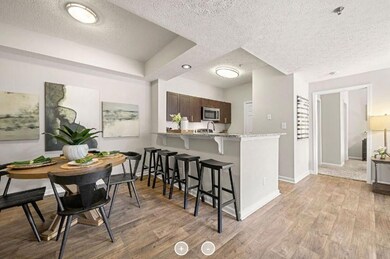Kitchen with a kitchen breakfast bar, light hardwo