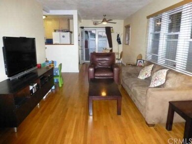 Living room with fabulous hardwood flooring greets