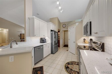 Updated kitchen with solid surface counters and walk-in pantry.