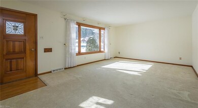 Living room with hardwood floors under carpet