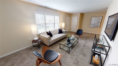 Living room viewing front entrance with coat closet.