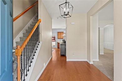 Foyer entrance with baseboards, wood finished floo