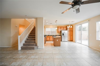 Kitchen with stainless steel fridge, a sink, a cha