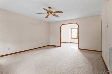 Unfurnished room featuring a textured ceiling, lig