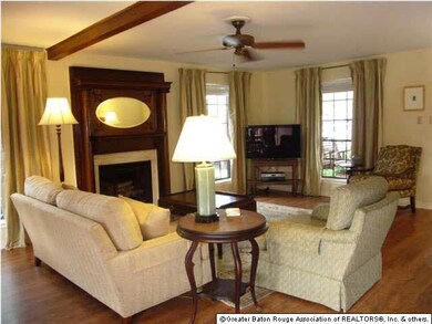 Living room with wood floors and beam. Floor to ce