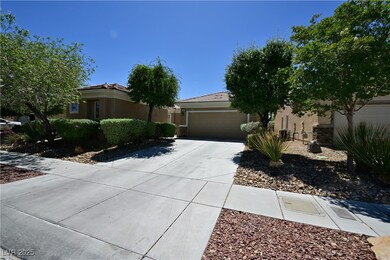 View of front of home with driveway, a garage, and