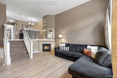 Living room with bright windows, new paint, and fireplace
