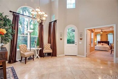 Another view of foyer w/custom drapes and downstai