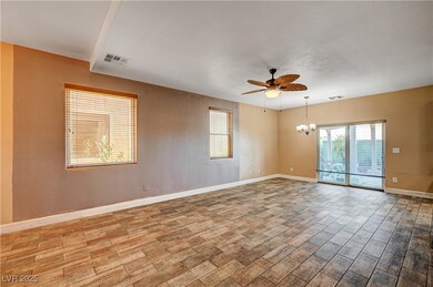 Unfurnished room featuring ceiling fan, wood finis