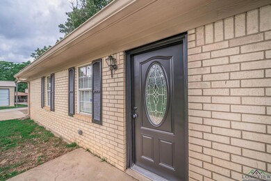 View of exterior entry with brick siding