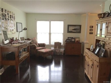 Formal living room with wood laminate flooring.