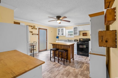 Kitchen with a breakfast bar, black electric range
