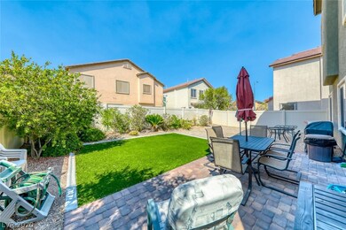 Tranquil rear yard with paver patio and synthetic