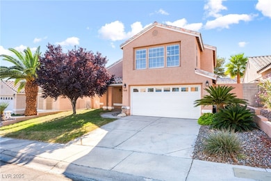 View of front of property featuring stucco siding, driveway, a garage, and a front lawn