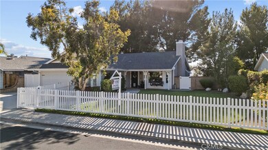 Huge front yard with a white picket fence.
