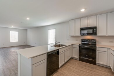 Kitchen featuring white cabinetry, kitchen peninsu