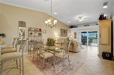 Dining area with ornamental molding, vaulted ceiling, light tile patterned floors, recessed lighting, and ceiling fan