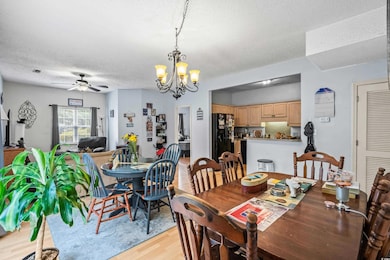 Dining room with a textured ceiling, ceiling fan w