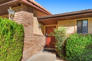 Entrance to property with stucco siding and brick siding