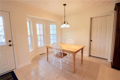 THE DINING AREA OF THE KITCHEN IS BRIGHT AND SUNNY