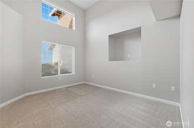 2nd bedroom with vaulted ceilings and shelving
