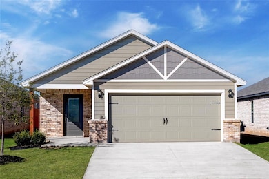 Charming curb appeal with brick and siding accents, a covered entry, and a spacious 2-car garage.
