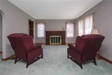 Spacious living room with fireplace (hardwood under carpet)