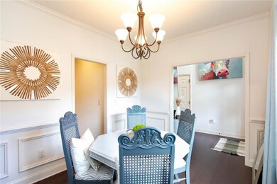 Dining space featuring a chandelier, dark wood fin