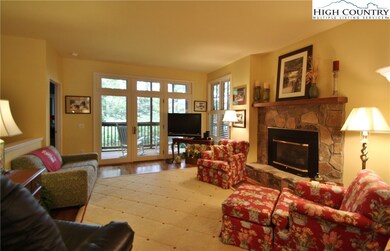 Spacious living area with gas log fireplace, wood