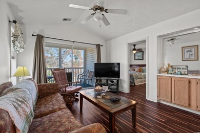 Living room with lofted ceiling and dark hardwood 