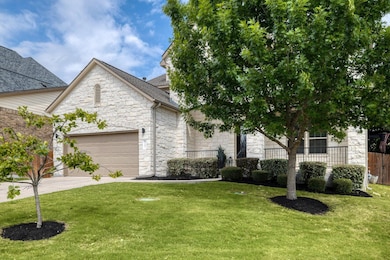 View of front of home with stone siding, an attac