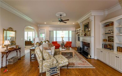 Living room has archways to the casual dining area