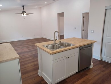 Kitchen featuring butcher block counters, dishwas