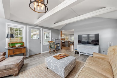 Cathedral beamed ceiling family room with access to deck