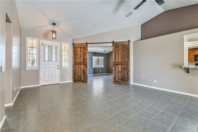 Tiled foyer entrance with a barn door, a ceiling f