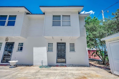 View of front facade with stucco siding and a patio
